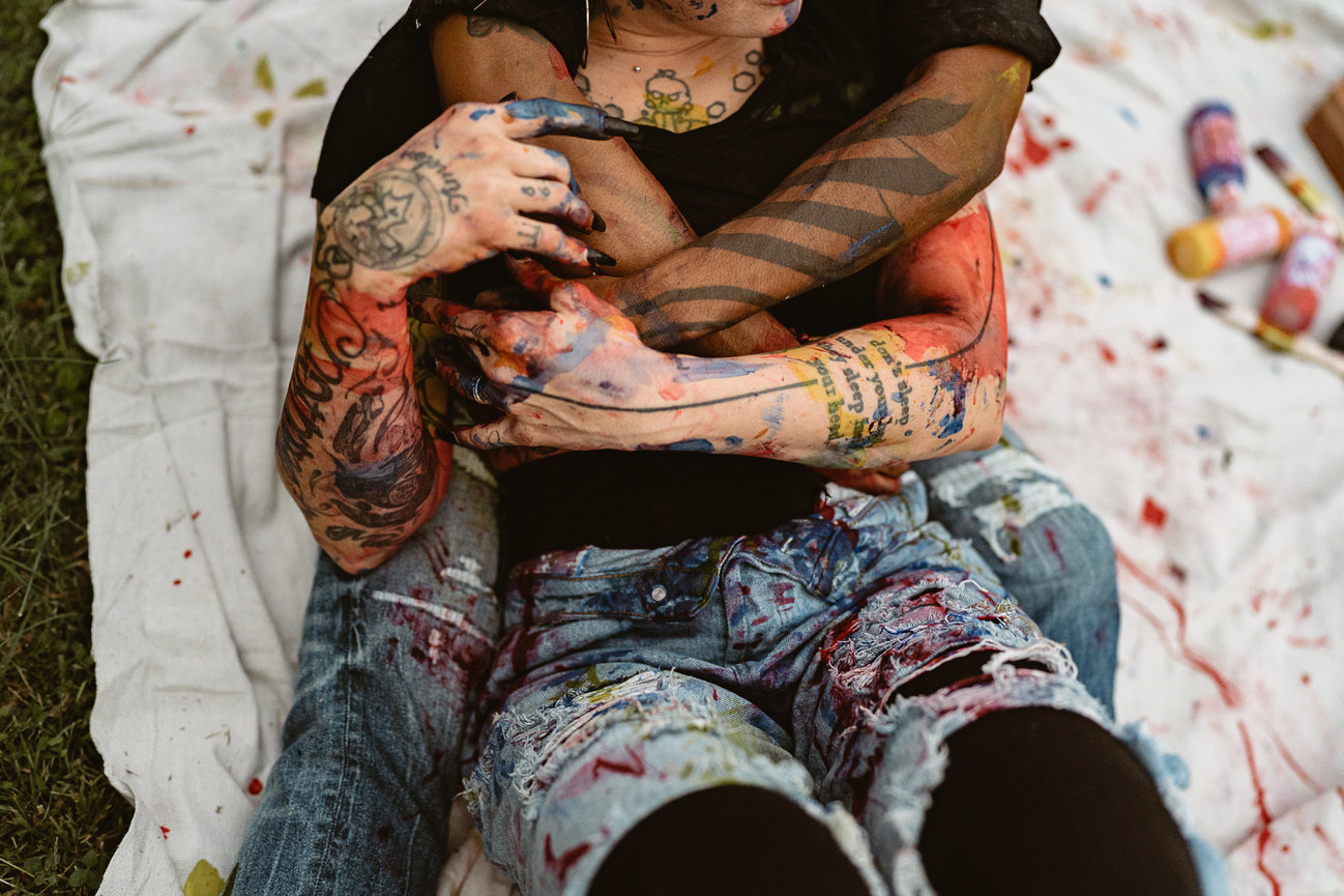 Couple intertwined with paint splatters