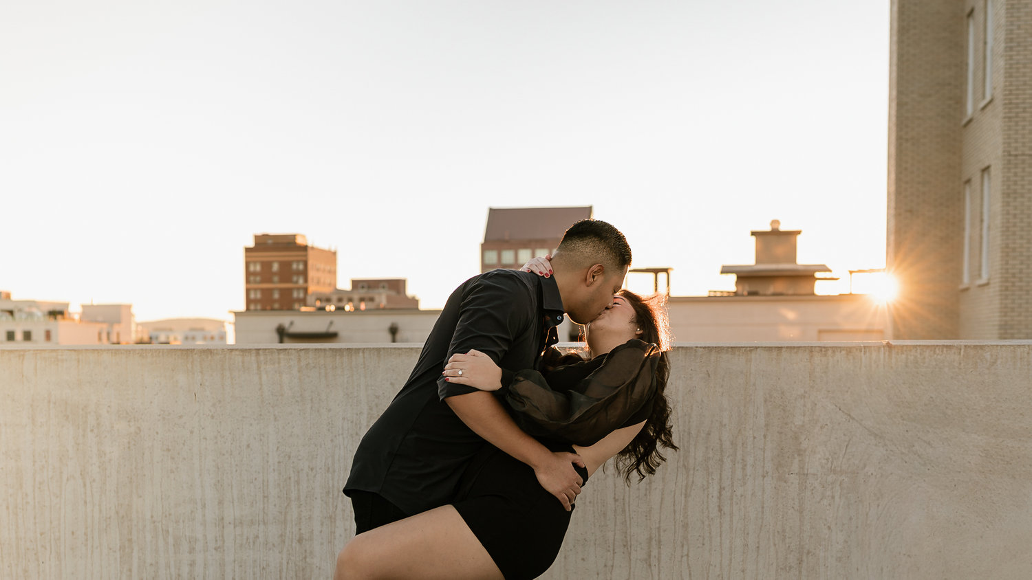 Couple capturing sunset on a rooftop
