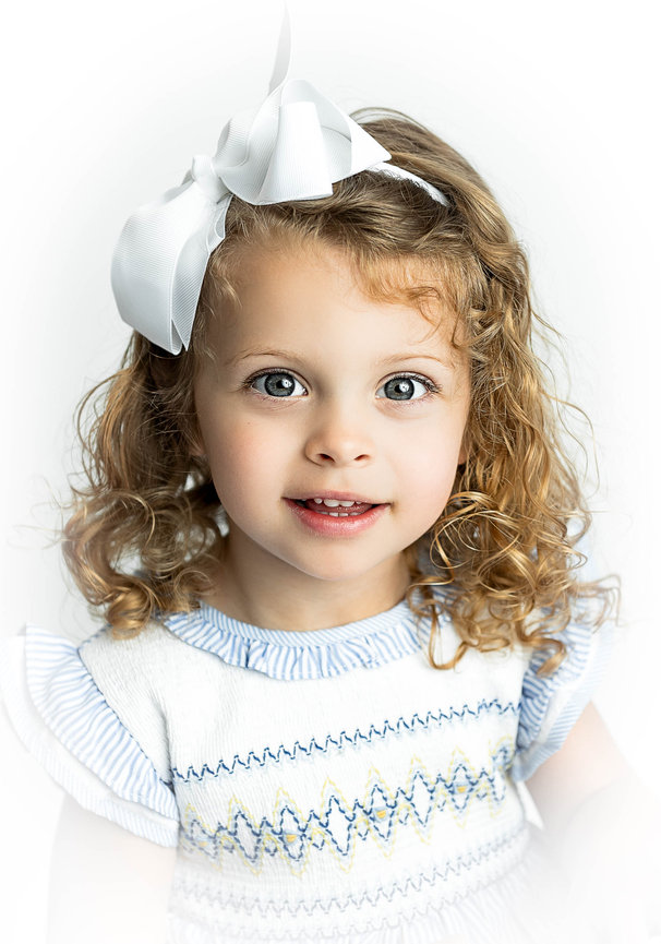 Studio portrait of toddler in vintage dress with soft focus background
