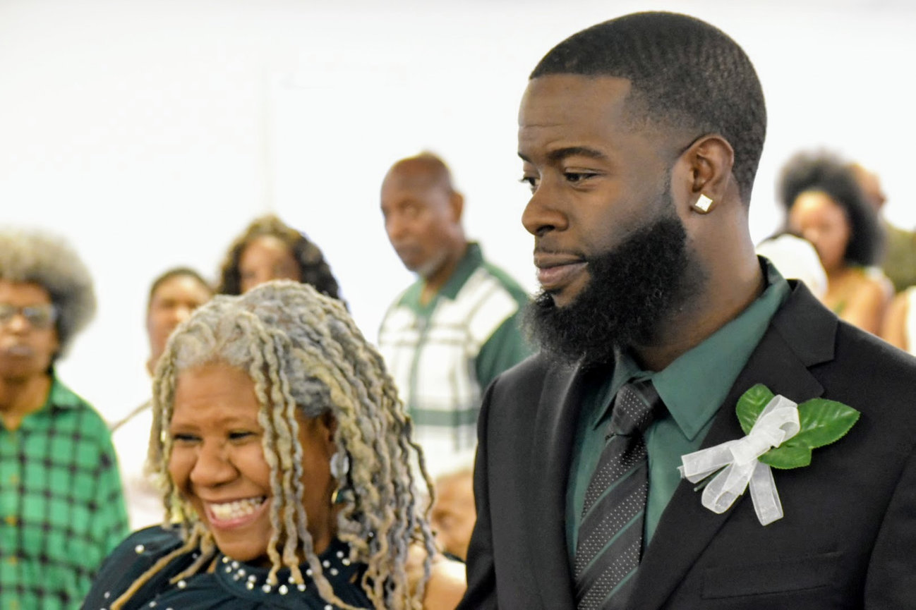 Man in a suit with a boutonniere at a formal celebration