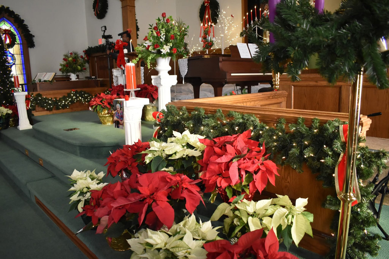 Wedding altar decorated with red and white floral arrangements
