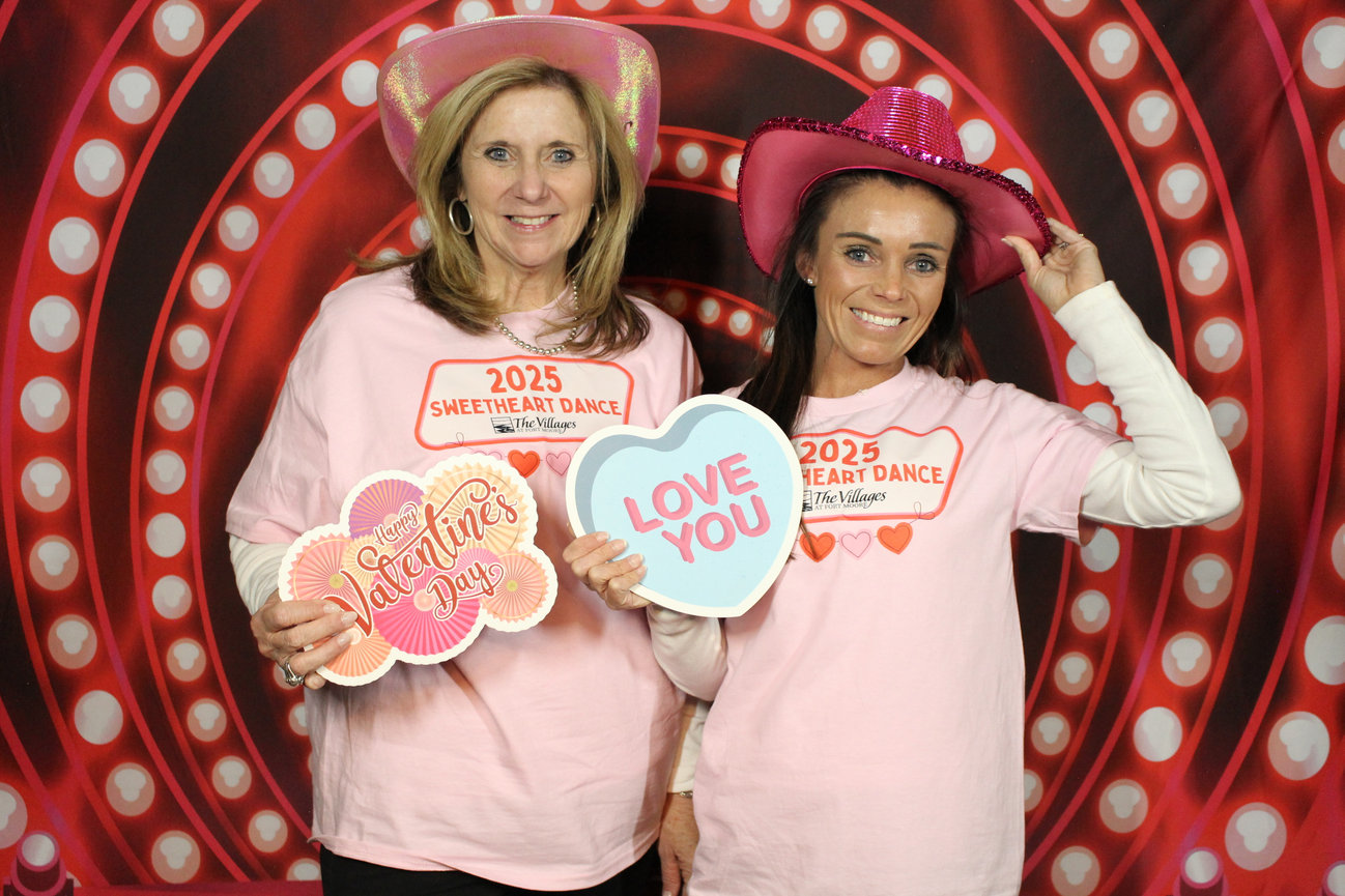 Happy guests posing with props at photo booth
