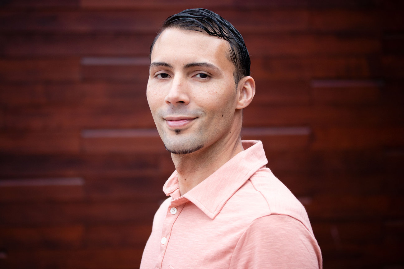 Man smiling with wood background