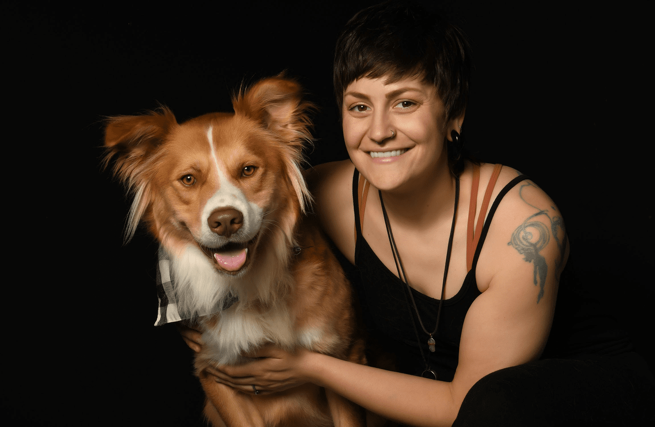 Vegan cook and animal rights advocate, Nikki, with her arms wrapped around her rescue dog Zeus at Kliks Photography.