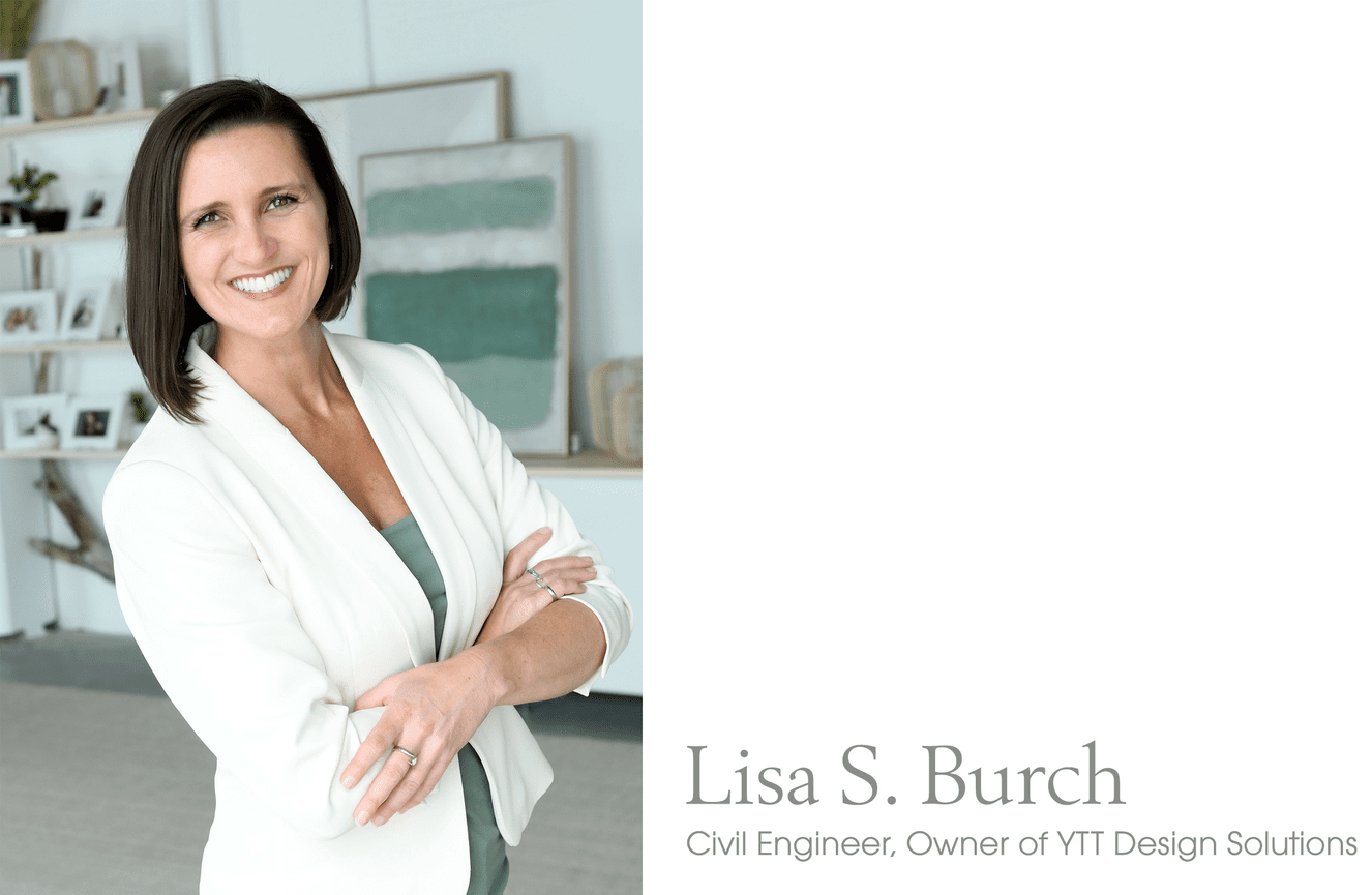 Civil Engineer, Lisa, smiles widely with her arms crossed wearing her professional white suit.