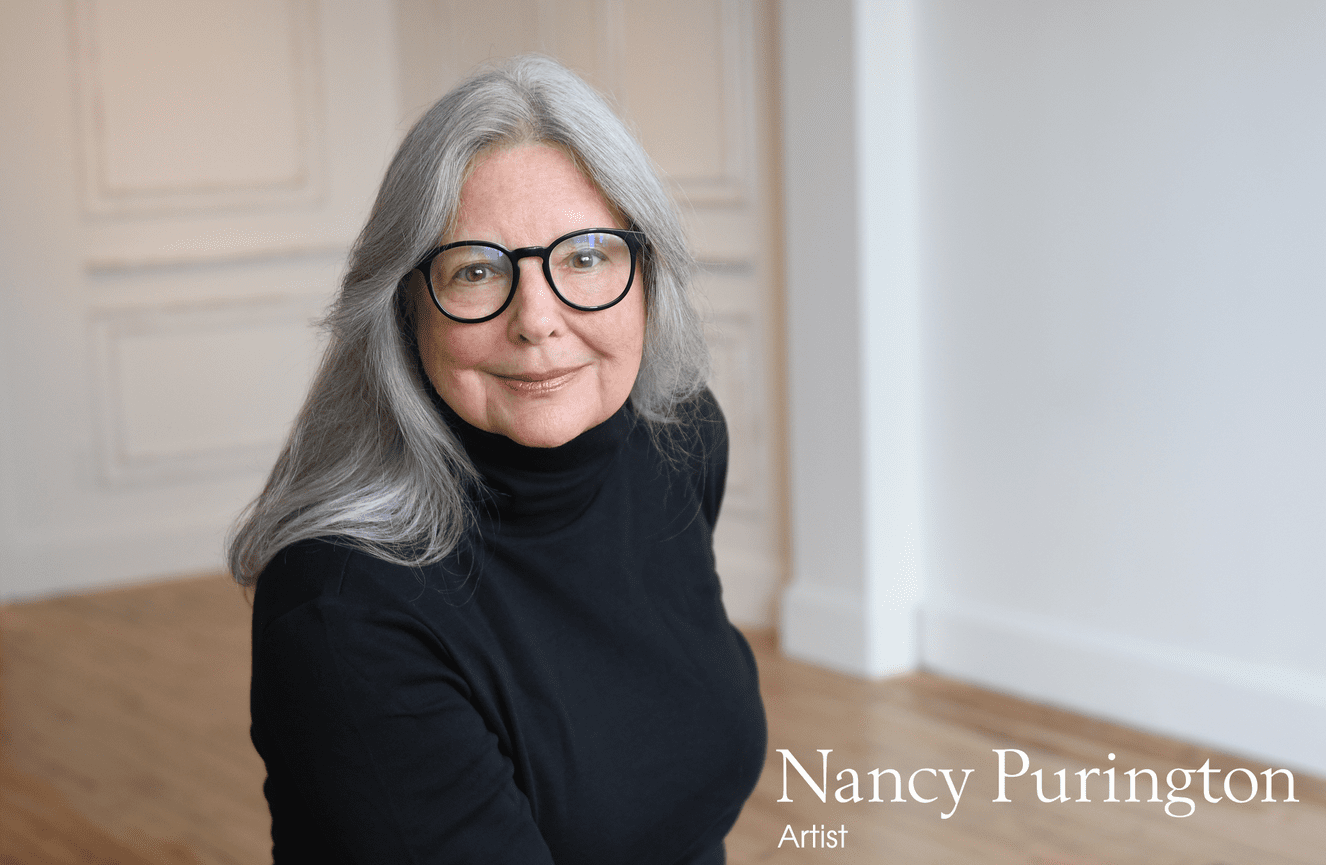 Nancy, a seasoned painter, poses for a bio photo for her upcoming museum exhibition.