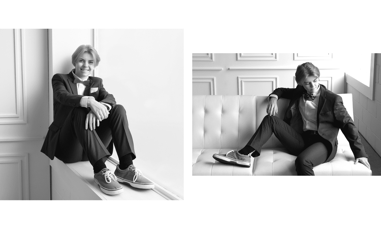 A senior in a bow tie and suit posing for senior photos at Kliks Photography in Cedar Rapids.