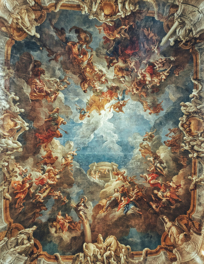 Ornate ceiling mural with vibrant clouds, figures, and architectural elements in a classical, mythological style.